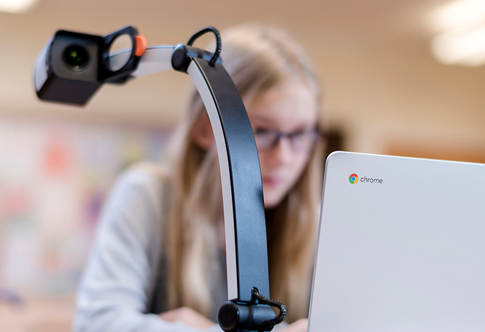 A student is using MagniLink S and a Chromebook with ChromeViewer in school.