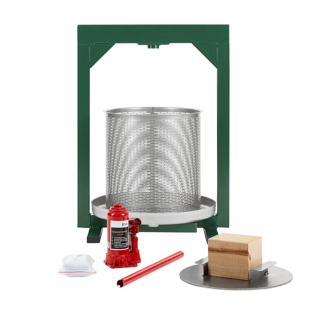 En sylindrisk pressekurv i rustfritt stål med grønne detaljer og diverse tilbehør plassert foran