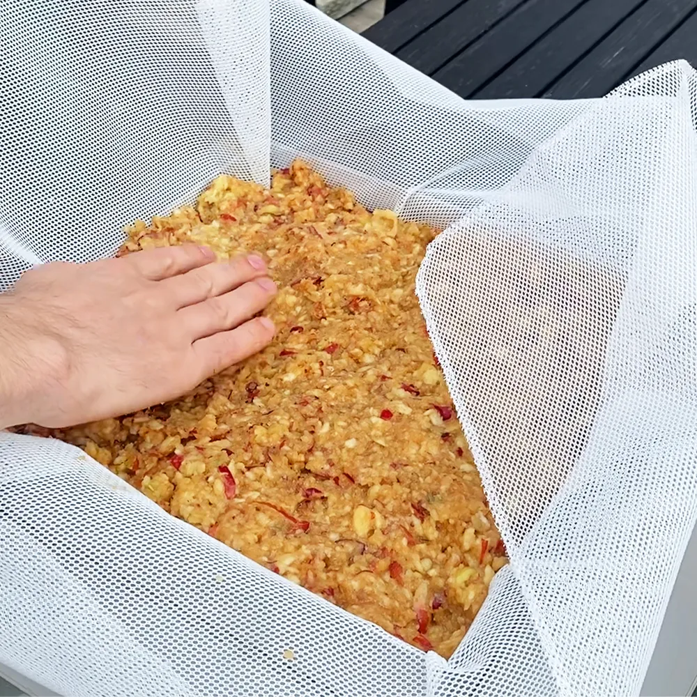 Filtret till packpressen placeras och fylls med äppelkross för att göras till must