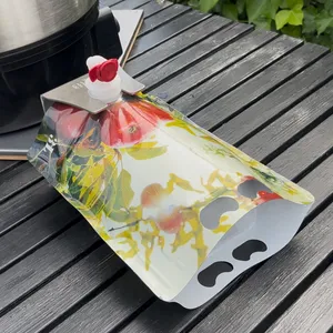 En rød og grønn stående pose fylt med juice plasseres i en BIB-holder for stabil fylling og forsegling