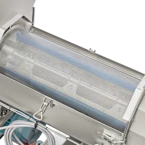 En luge, der kan åbnes, fjernes på maskinen for at afsløre den indvendige cylindriske sigte