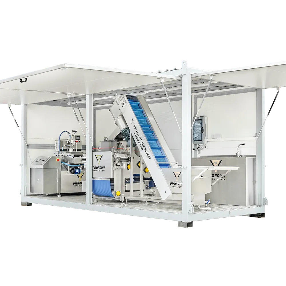 Større maskiner for produksjon av eplejuice plassert i en container med åpningsbare sider.