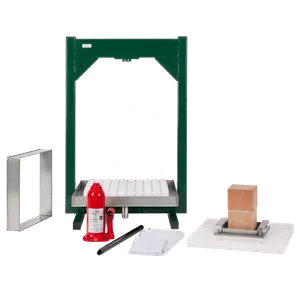 Hydraulisk fruktpress med pressram, vita pressplattor, träklossar och röd domkraft under montering