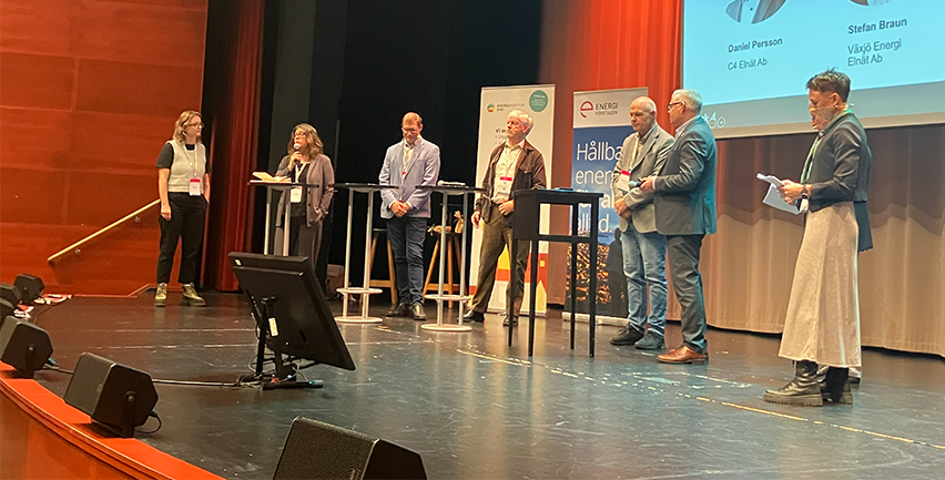 Paneldeltagare som pratar på en scen.