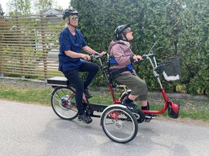 Tandemcykel med handikappsanpassning. Brukaren sitter fram och personalen bakom och trampar.