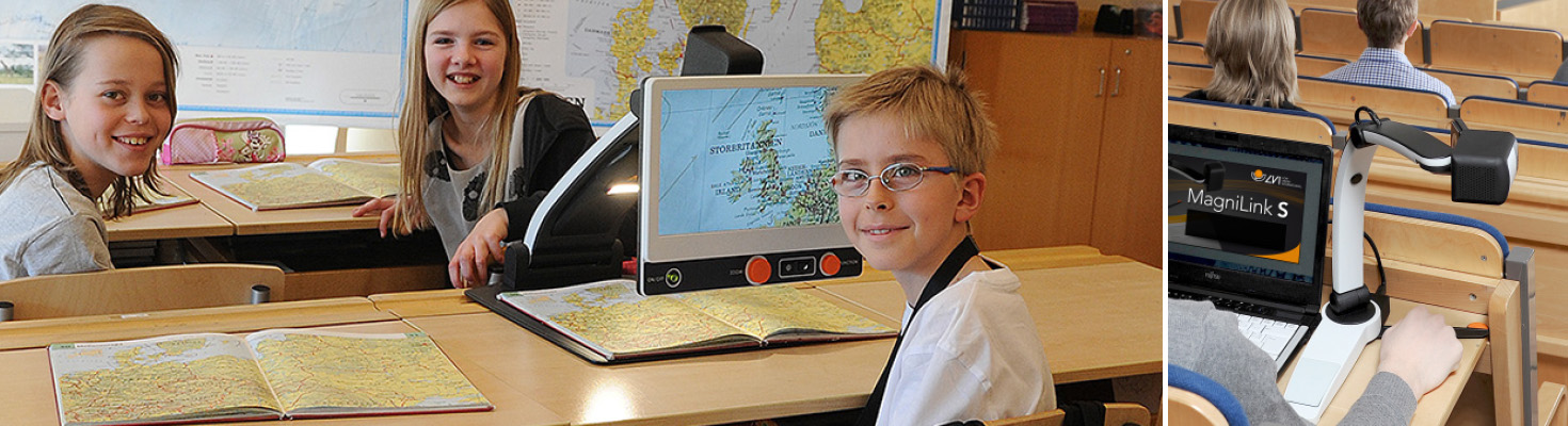 Three younger school students in a classroom where one of them uses the MagniLink Zip video magnifier to look in a map book.