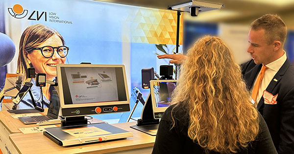 Photo showing Christofer Casswall from LVI Sweden showcasing a MagniLink Zip for a visitor at ATIA in 2023.