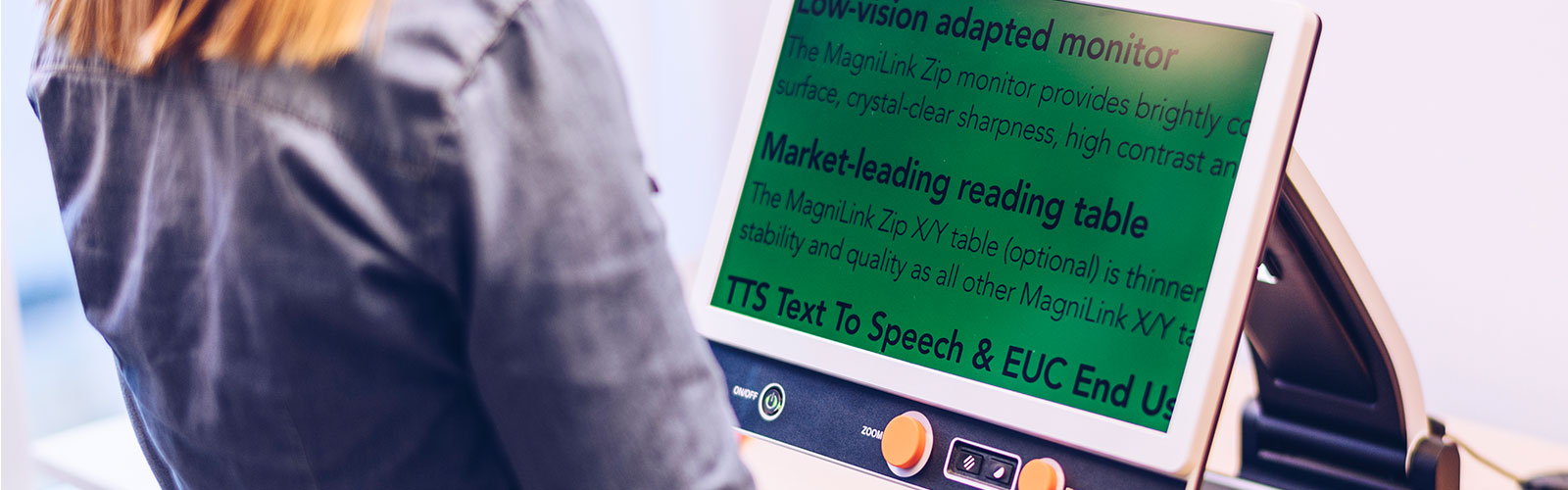 A visually impaired woman is using the MagniLink Zip and sees enlarged text on the screen.