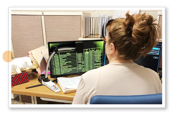 Rebecca is using the video magnifier MagniLink S (MLS) combined with a 24” screen.